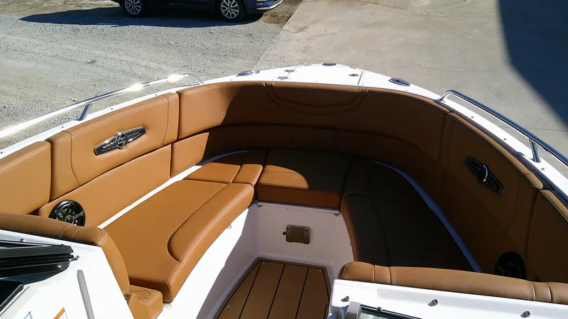 Slide: The Image of 2024 Chaparral 28 Surf boat interior with brown leather seating. - 10