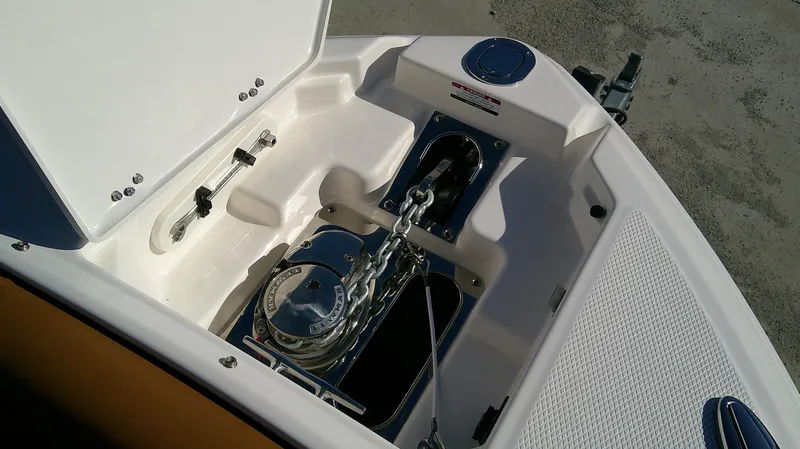 Slide: The Image of 2024 Chaparral 28 Surf boat anchor compartment with chain and winch. - 11