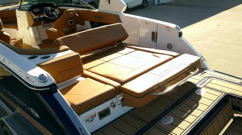 Slide: The Image of 2024 Chaparral 28 Surf boat with luxurious tan seating and modern dashboard. - 4
