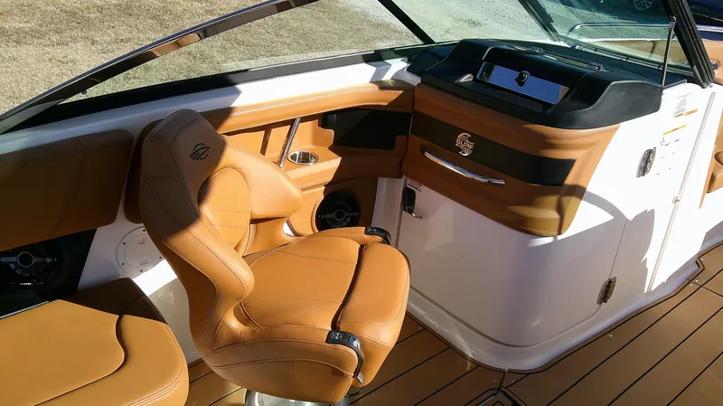 Slide: The Image of 2024 Chaparral 28 Surf boat interior with tan leather seating and sleek dashboard design. - 8