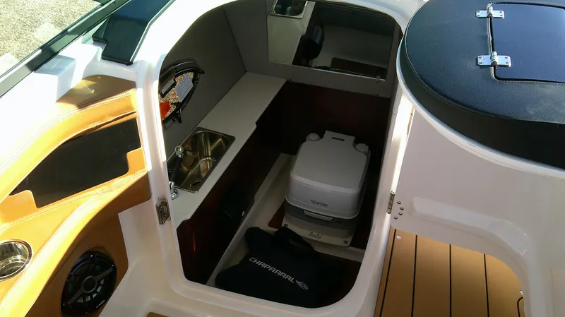 Slide: The Image of 2024 Chaparral 28 Surf interior cabin with sink and portable toilet. - 9