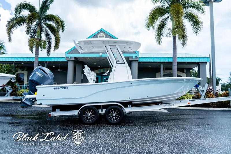 The Image of 2024 Sea Fox 231 Bay Fox Center Console boat on trailer, displayed outdoors. - 1