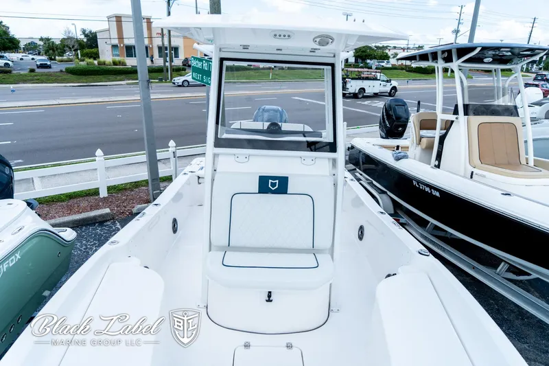 Slide: The Image of 2024 Sea Fox 231 Bay Fox Center Console boat displayed at a dealership. - 11