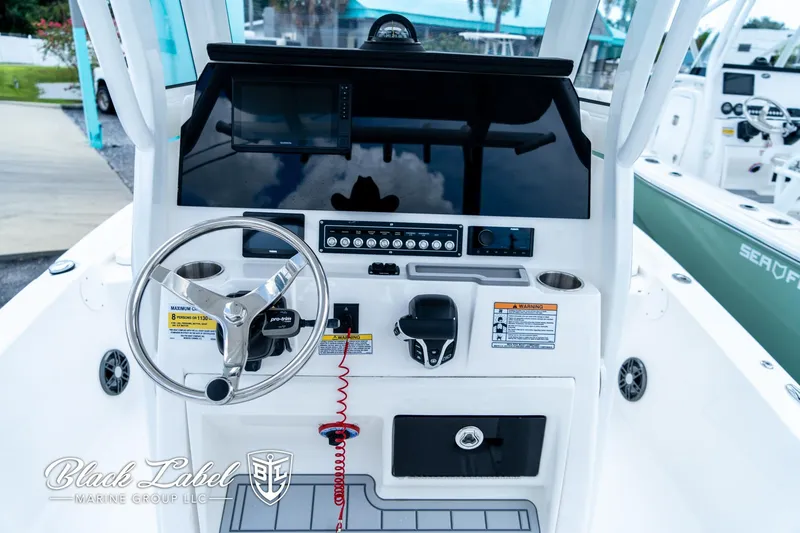 Slide: The Image of 2024 Sea Fox 231 Bay Fox Center Console dashboard with steering wheel and controls. - 15