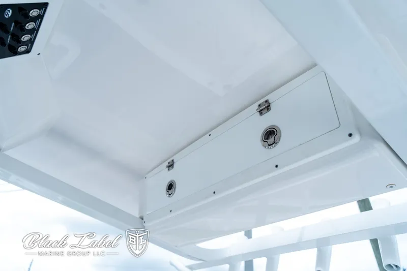 Slide: The Image of 2024 Sea Fox 231 Bay Fox Center Console storage compartment, featuring sleek design and secure latches. - 23