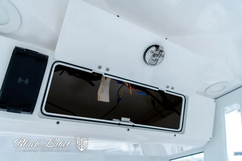 Slide: The Image of 2024 Sea Fox 231 Bay Fox Center Console storage compartment with Black Label Marine Group branding. - 26
