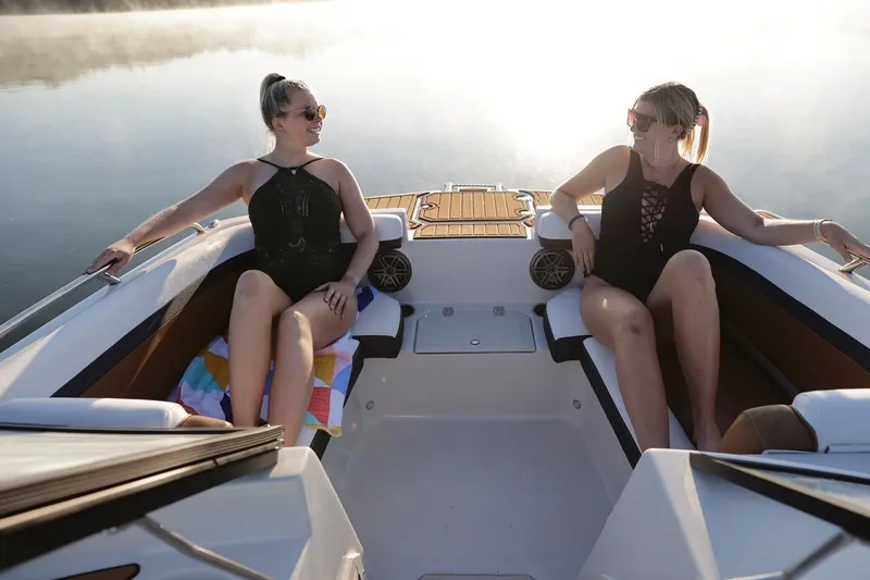 Slide: The Image of Two women relaxing on a 2026 Starcraft SVX 231 IO boat. - 9