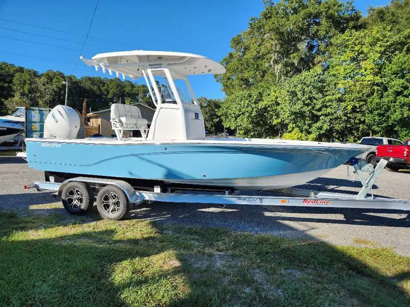 Slide: The Image of 2024 Sea Fox 231 Bay Fox Center Console boat on a trailer, side view. - 1