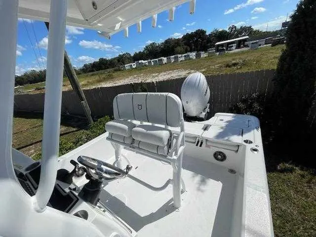 Slide: The Image of 2024 Sea Fox 231 Bay Fox Center Console boat with dual seats and steering wheel. - 14