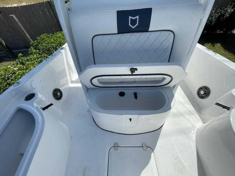 Slide: The Image of 2024 Sea Fox 231 Bay Fox Center Console boat interior with open storage compartment. - 18