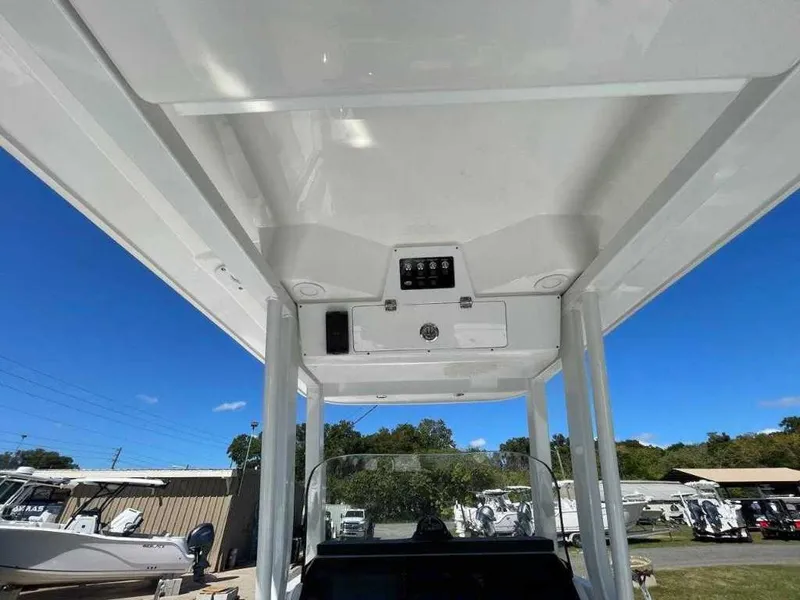 Slide: The Image of 2024 Sea Fox 231 Bay Fox Center Console boat interior view with T-top and console. - 20