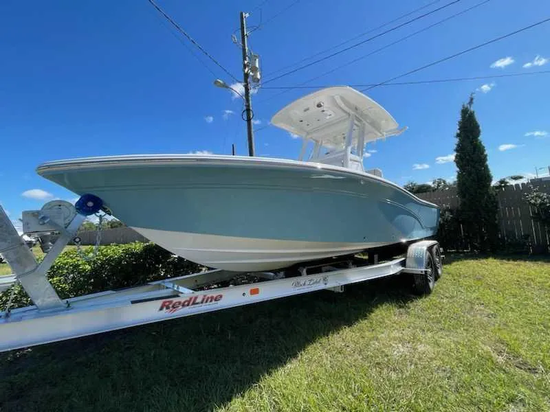 Slide: The Image of 2024 Sea Fox 231 Bay Fox Center Console boat on trailer, side view. - 6