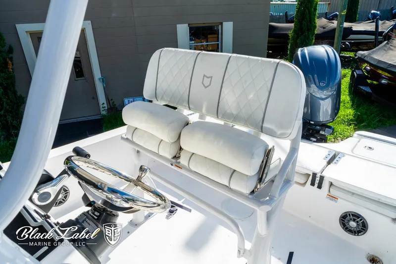 Slide: The Image of 2024 Sea Fox 231 Bay Fox Center Console interior with steering wheel and cushioned seating. - 12