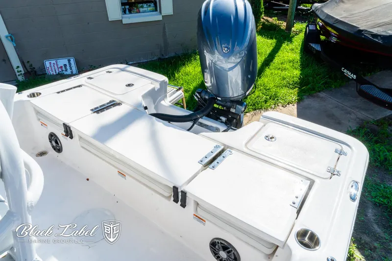 Slide: The Image of 2024 Sea Fox 231 Bay Fox Center Console boat with outboard motor, docked outdoors. - 21