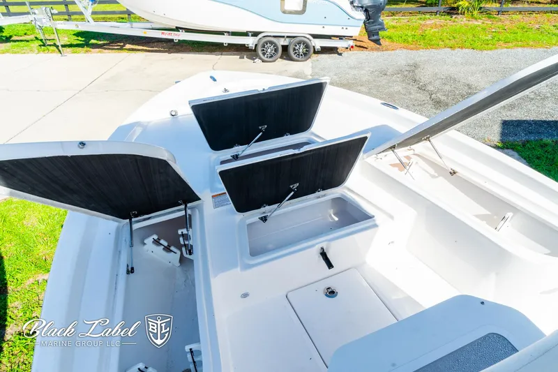 Slide: The Image of 2024 Sea Fox 231 Bay Fox Center Console with open storage compartments. - 9