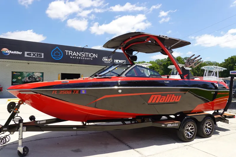 Slide: The Image of 2023 Malibu 23 LSV boat on trailer at Transition Watersports dealership. - 1