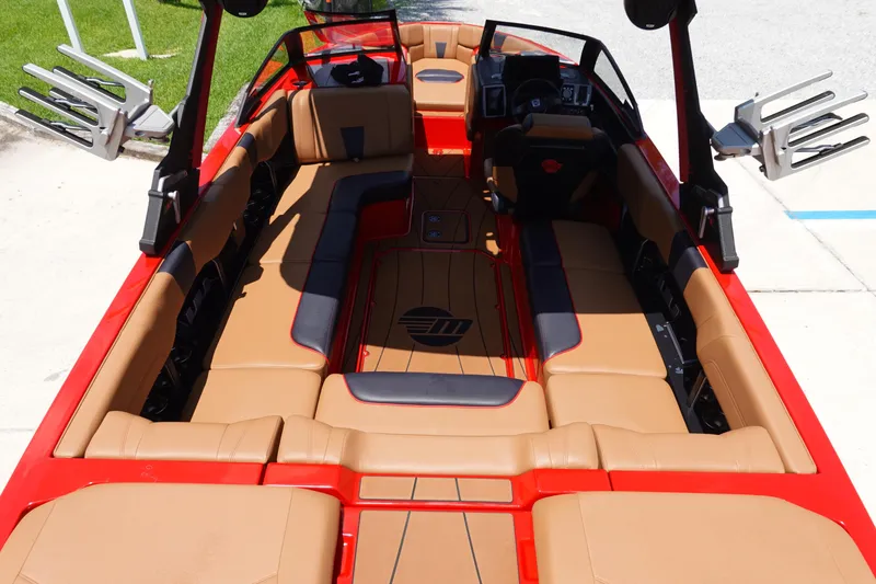 Slide: The Image of 2023 Malibu 23 LSV boat interior with tan and red seating. - 11
