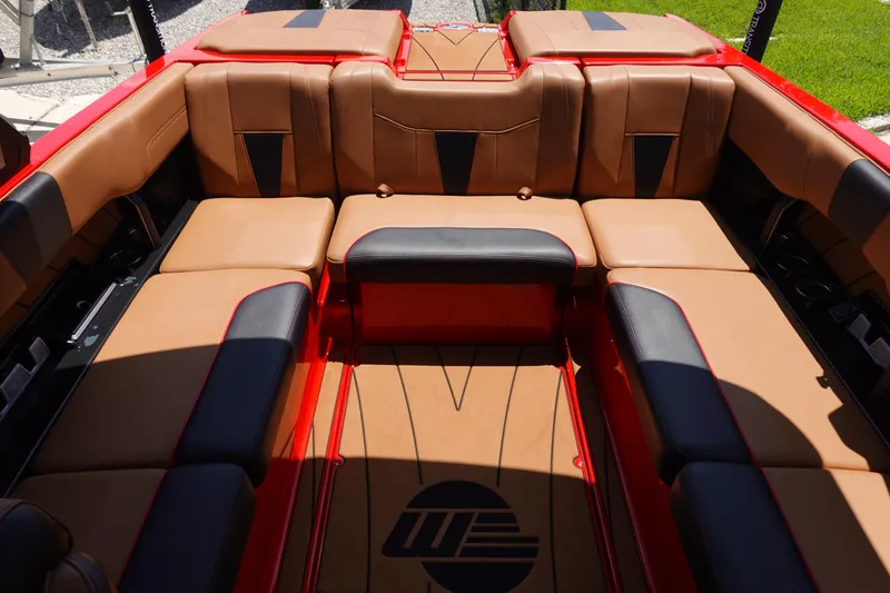 Slide: The Image of 2023 Malibu 23 LSV boat interior with tan and black seating. - 12