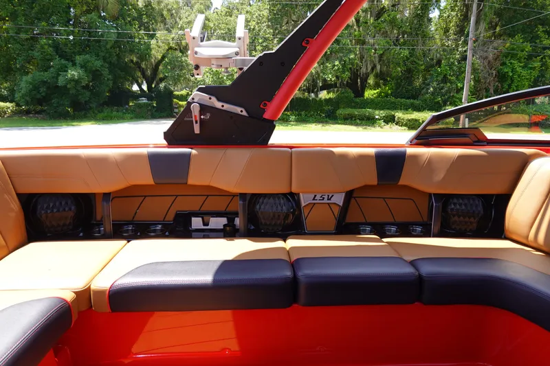 Slide: The Image of 2023 Malibu 23 LSV boat interior with tan and black seating. - 15