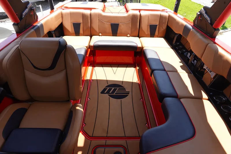 Slide: The Image of 2023 Malibu 23 LSV boat interior with tan and black seating. - 21