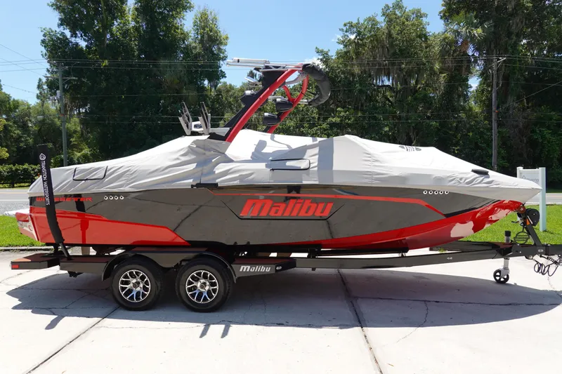 Slide: The Image of 2023 Malibu 23 LSV boat with cover on trailer. - 29