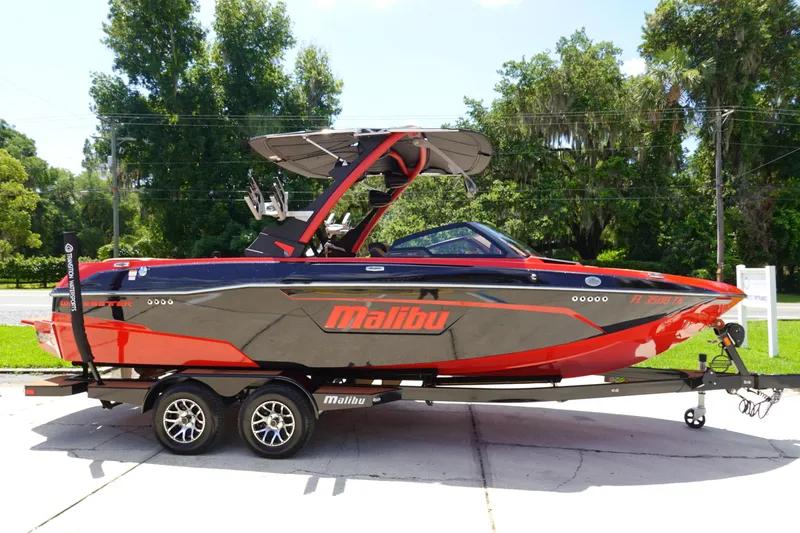 Slide: The Image of 2023 Malibu 23 LSV boat in black and red on a trailer. - 4