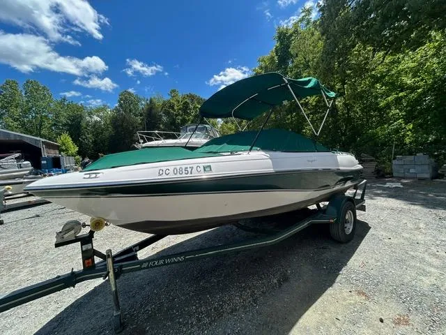 The Image of 2005 Four Winns 190 Horizon LE boat on trailer with green canopy. - 0