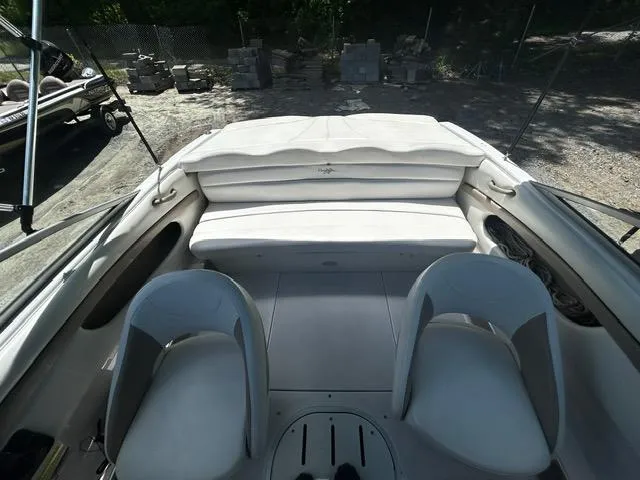 Slide: The Image of 2005 Four Winns 190 Horizon LE boat interior with white seating and dual chairs. - 15