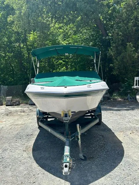 Slide: The Image of 2005 Four Winns 190 Horizon LE boat with green cover on trailer. - 3
