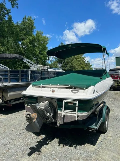 Slide: The Image of 2005 Four Winns 190 Horizon LE boat with green canopy in outdoor storage. - 4