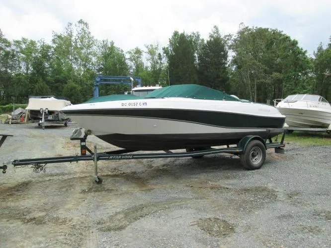 Slide: The Image of 2005 Four Winns 190 Horizon LE boat on trailer, covered, parked outdoors. - 6