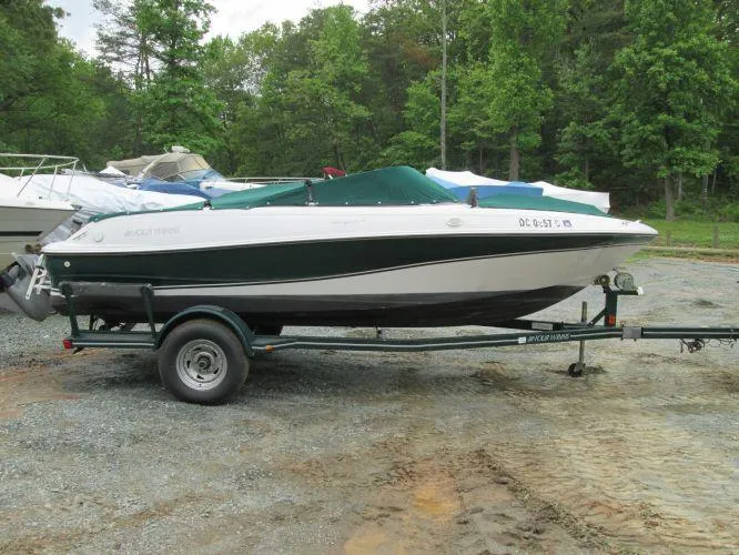 Slide: The Image of 2005 Four Winns 190 Horizon LE boat on a trailer in a wooded area. - 7