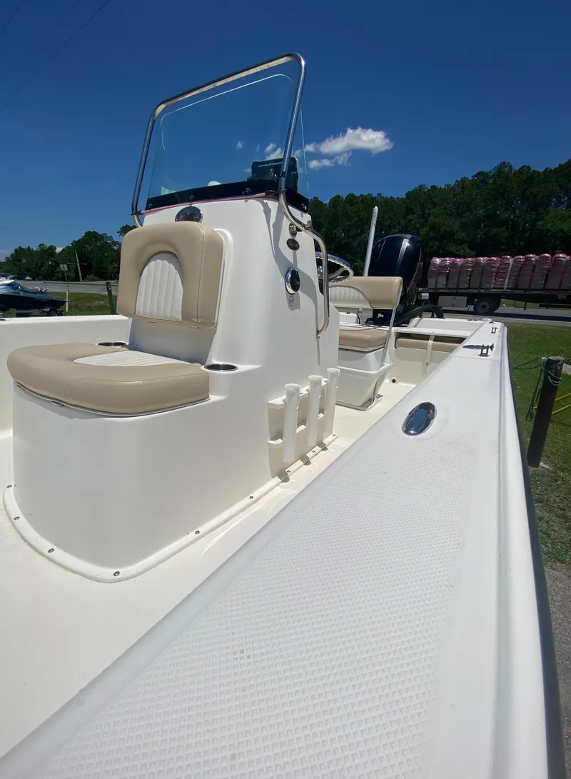 Slide: The Image of 2017 Sundance DX 22 boat with beige seating and console. - 10