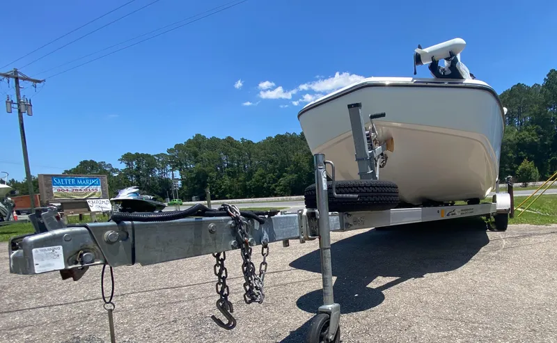 Slide: The Image of 2017 Sundance DX 22 boat on trailer in sunny outdoor setting. - 11