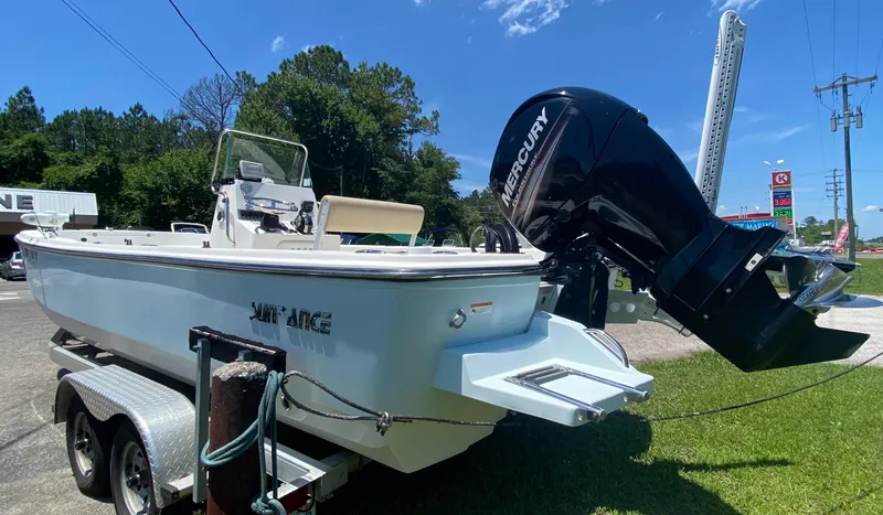 Slide: The Image of 2017 Sundance DX 22 boat on trailer with Mercury outboard motor. - 2