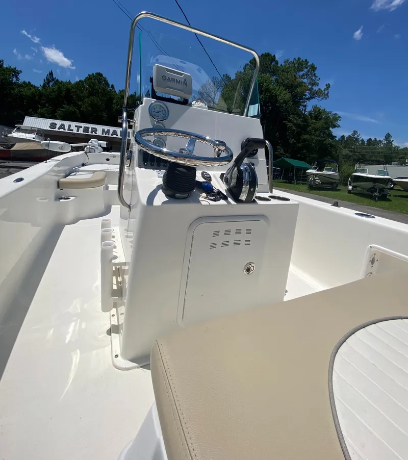 Slide: The Image of 2017 Sundance DX 22 boat interior with steering console and seating. - 4