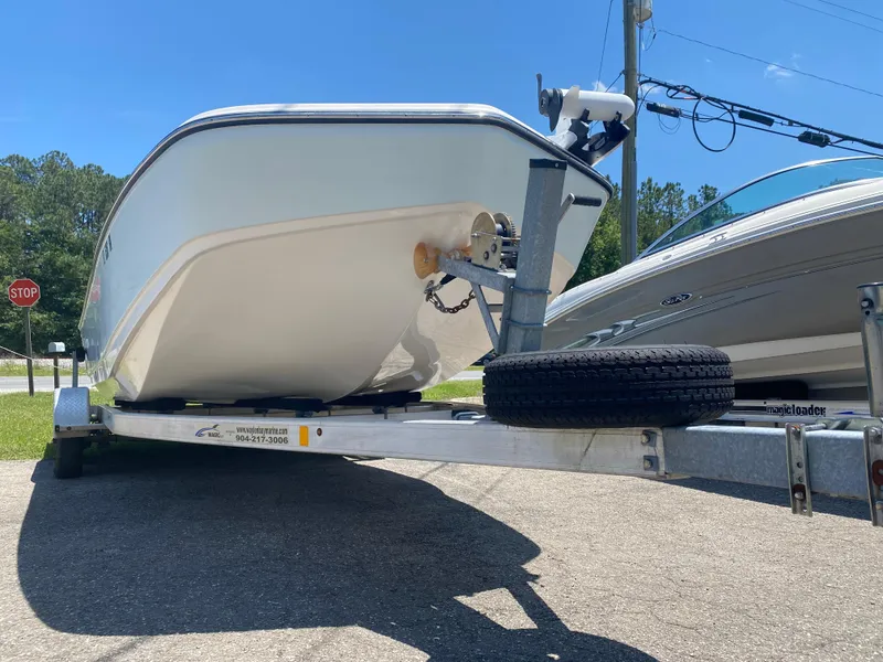 Slide: The Image of 2017 Sundance DX 22 boat on a trailer in a parking lot. - 8