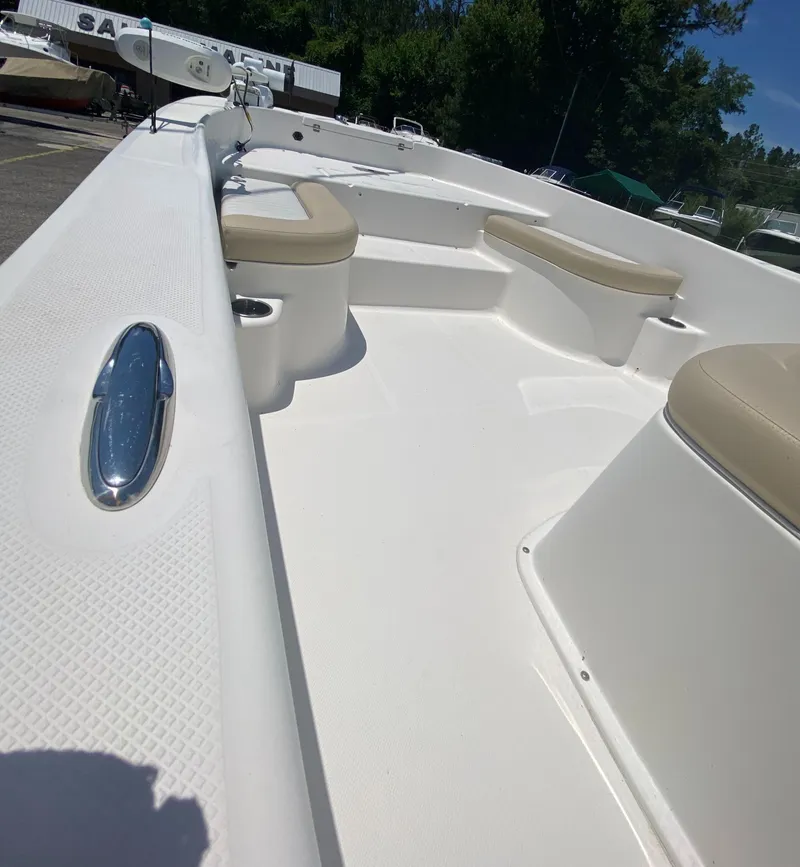 Slide: The Image of 2017 Sundance DX 22 boat interior with seating and storage compartments. - 9