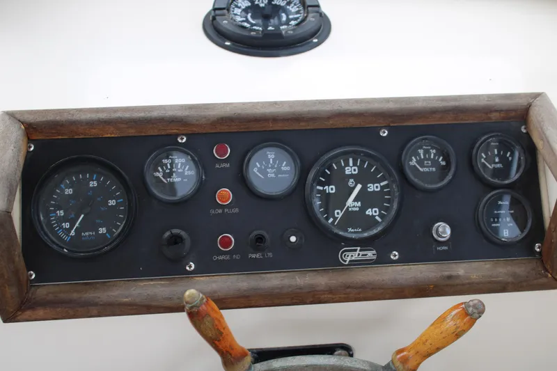 Slide: The Image of Dashboard of a 1996 Webbers Cove 26 boat with gauges and controls. - 12