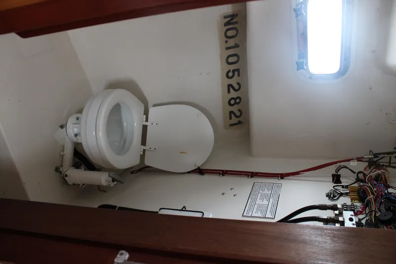 Slide: The Image of 1996 Webbers Cove 26 boat interior with toilet and wiring. - 24