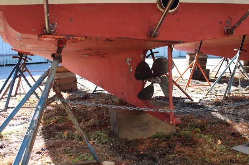 Slide: The Image of Webbers Cove 26 boat hull and propeller, 1996 model, on stands for maintenance. - 27