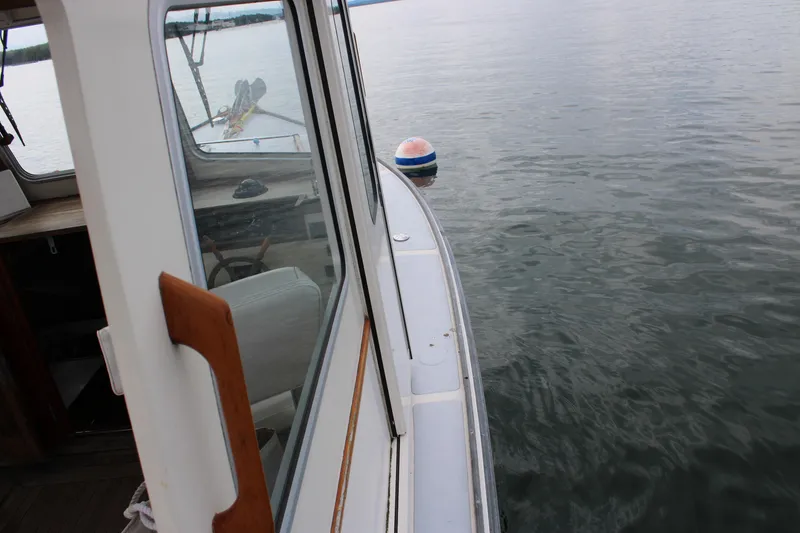 Slide: The Image of 1996 Webbers Cove 26 boat on calm water near a buoy. - 28