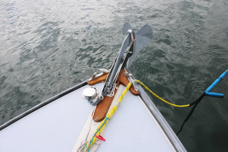 Slide: The Image of Bow of 1996 Webbers Cove 26 boat with anchor and ropes on water. - 29