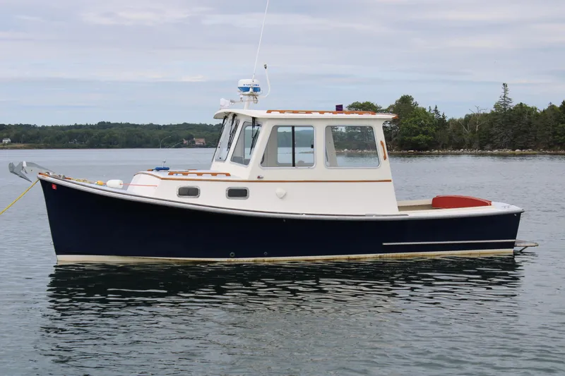 Slide: The Image of 1996 Webbers Cove 26 boat on calm water, side view. - 3