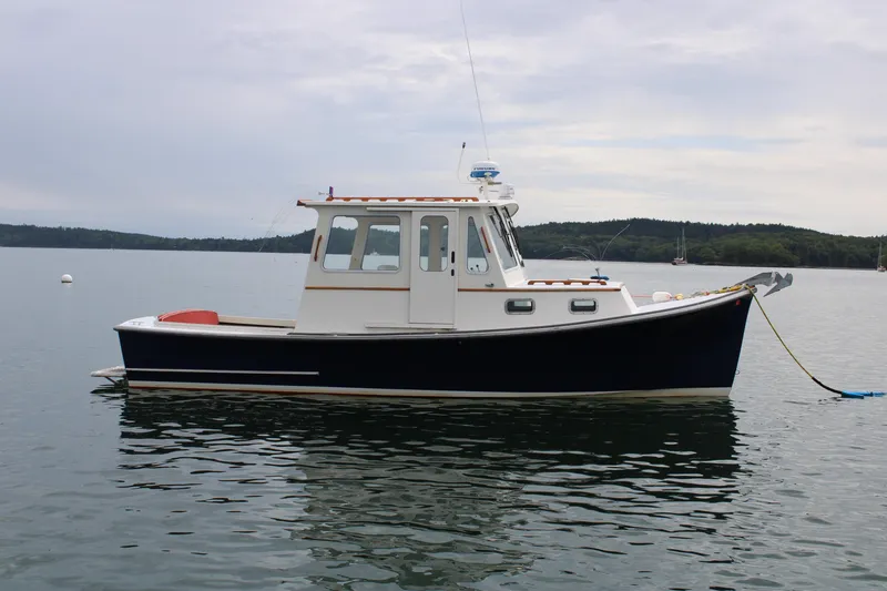 Slide: The Image of 1996 Webbers Cove 26 boat on calm water, side view, overcast sky. - 34
