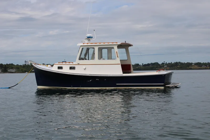 Slide: The Image of 1996 Webbers Cove 26 boat on calm water under cloudy sky. - 35