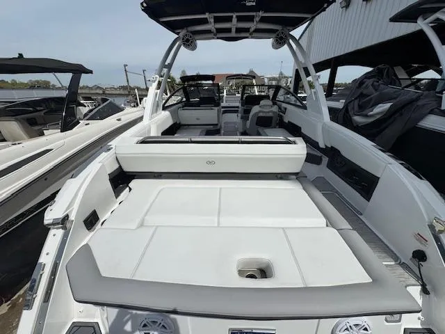 Slide: The Image of 2024 Cobalt R8 boat with spacious deck and seating, docked at marina. - 10