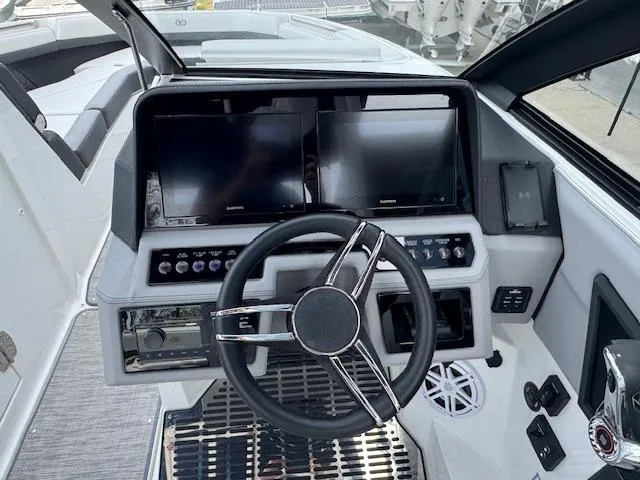 Slide: The Image of 2024 Cobalt R8 boat dashboard with dual screens and modern steering wheel. - 17