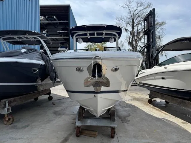 Slide: The Image of 2024 Cobalt R8 boat in storage, front view, flanked by other boats. - 3