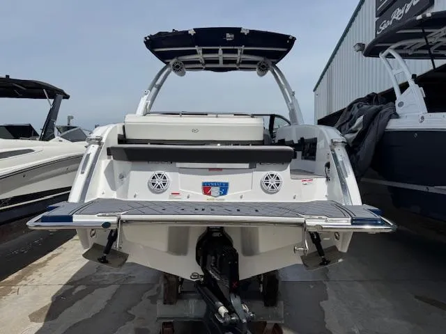 Slide: The Image of 2024 Cobalt R8 boat, rear view, docked, showcasing swim platform and speakers. - 4